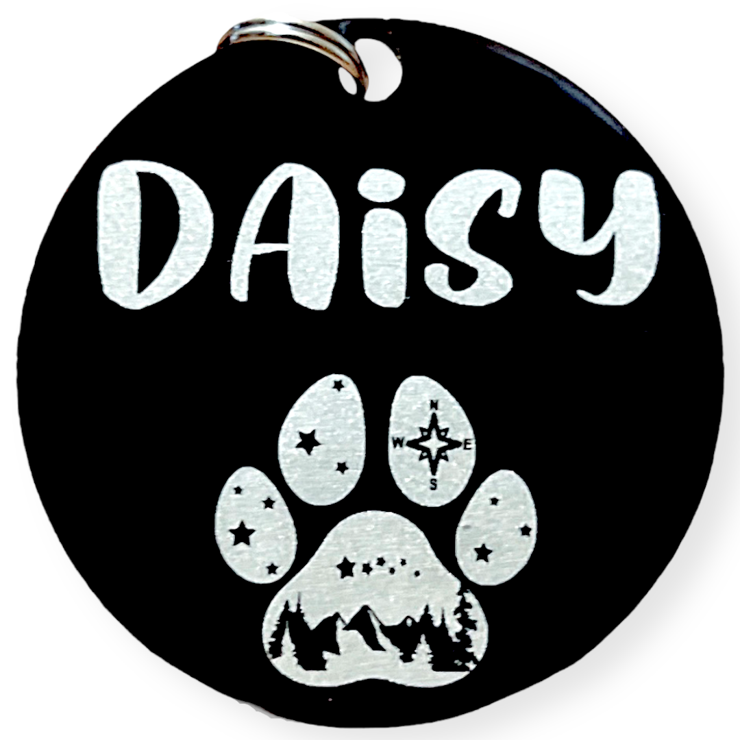 dog tag with paw design that has mountains inside of the paw